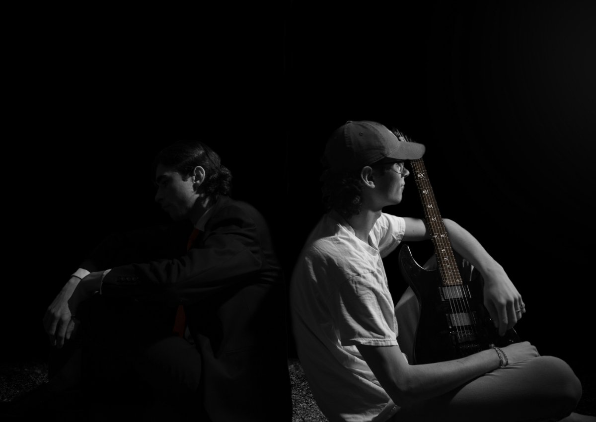 student photo of two musicians sitting back-to-back