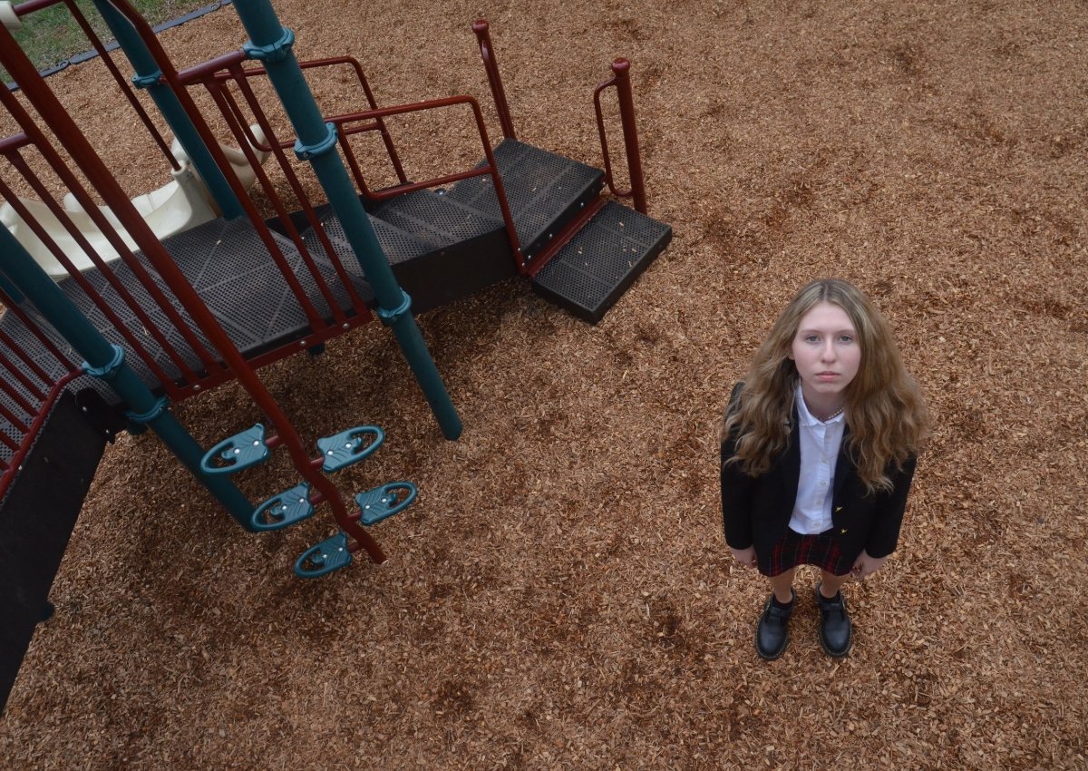 student photo of a girl standing in a playground