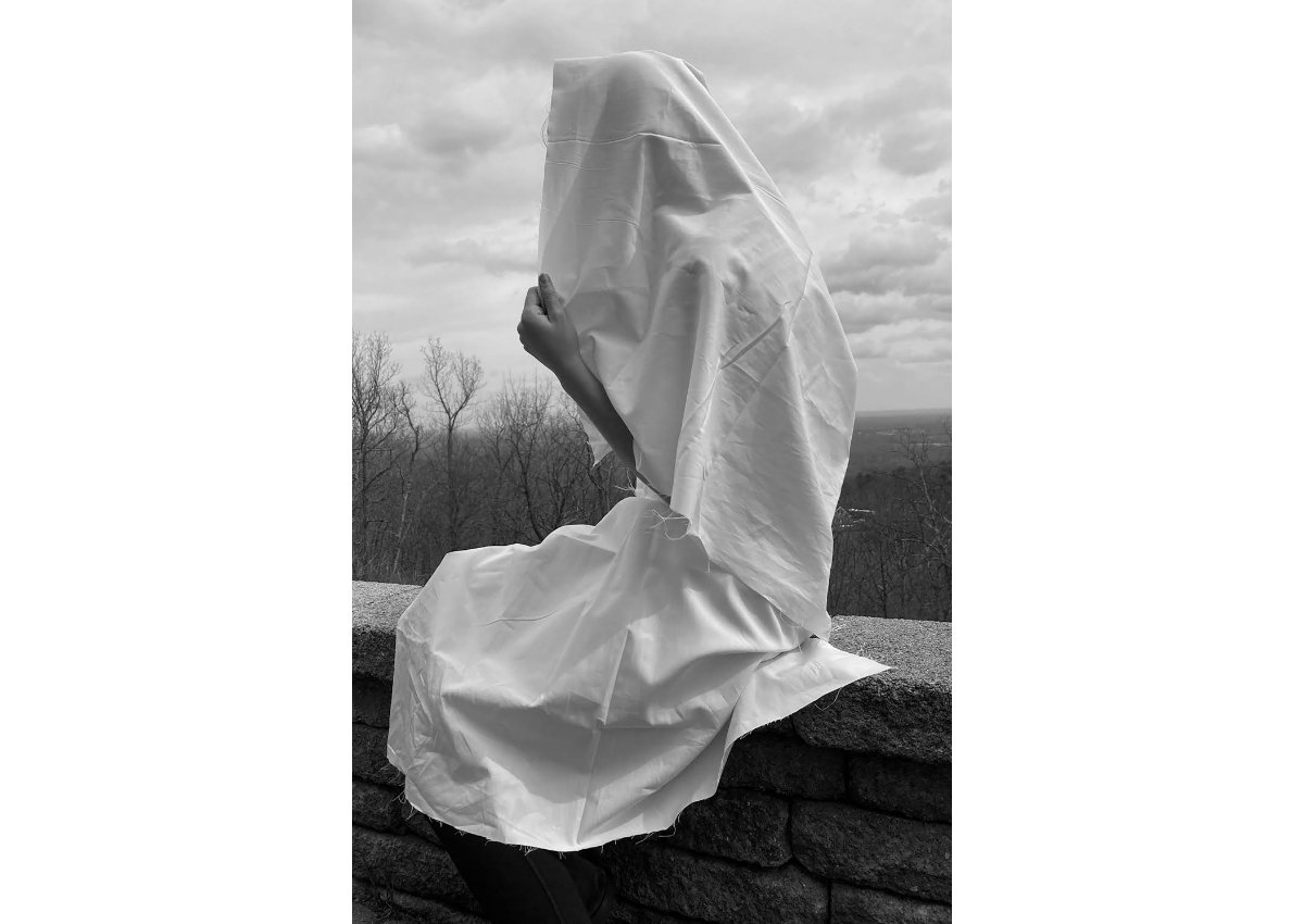 student photo of a person with a sheet draped over them