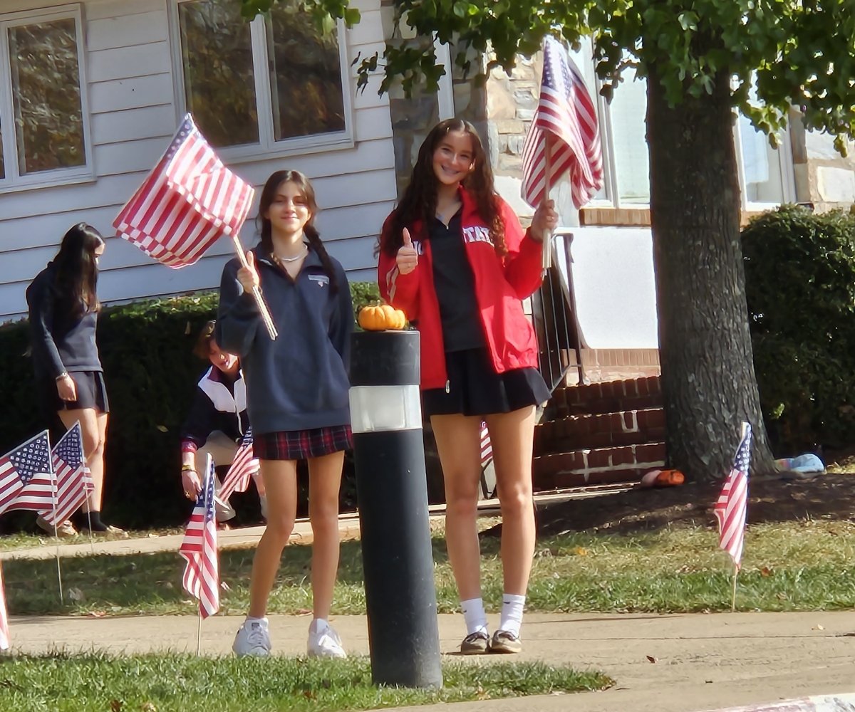 students outside holding American flags