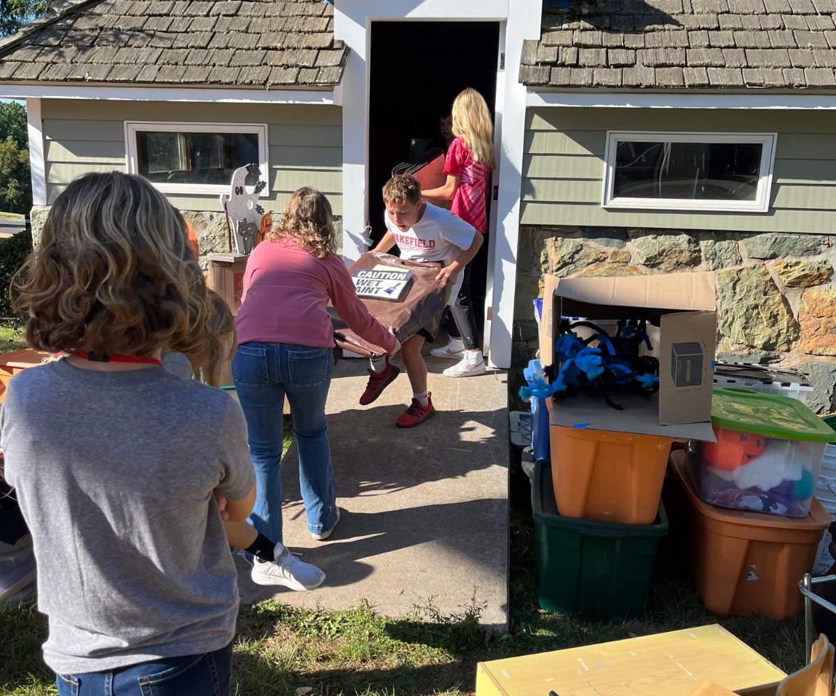students helping clear out a community shed