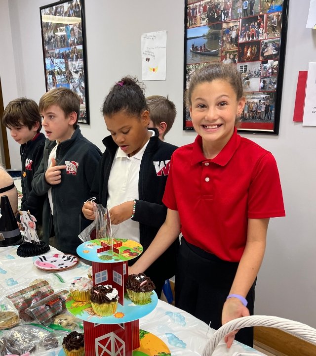 middle school students running a bake sale