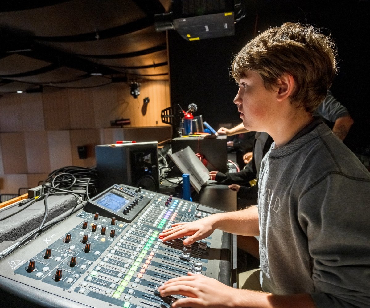 student using the auditorium sound and lighting board